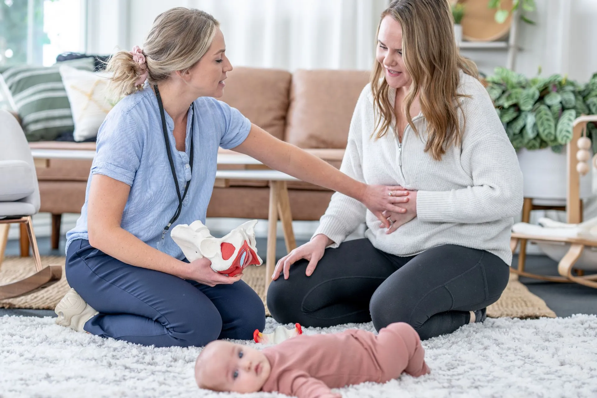 Clinician talking with a new mum about pelvic floor recovery