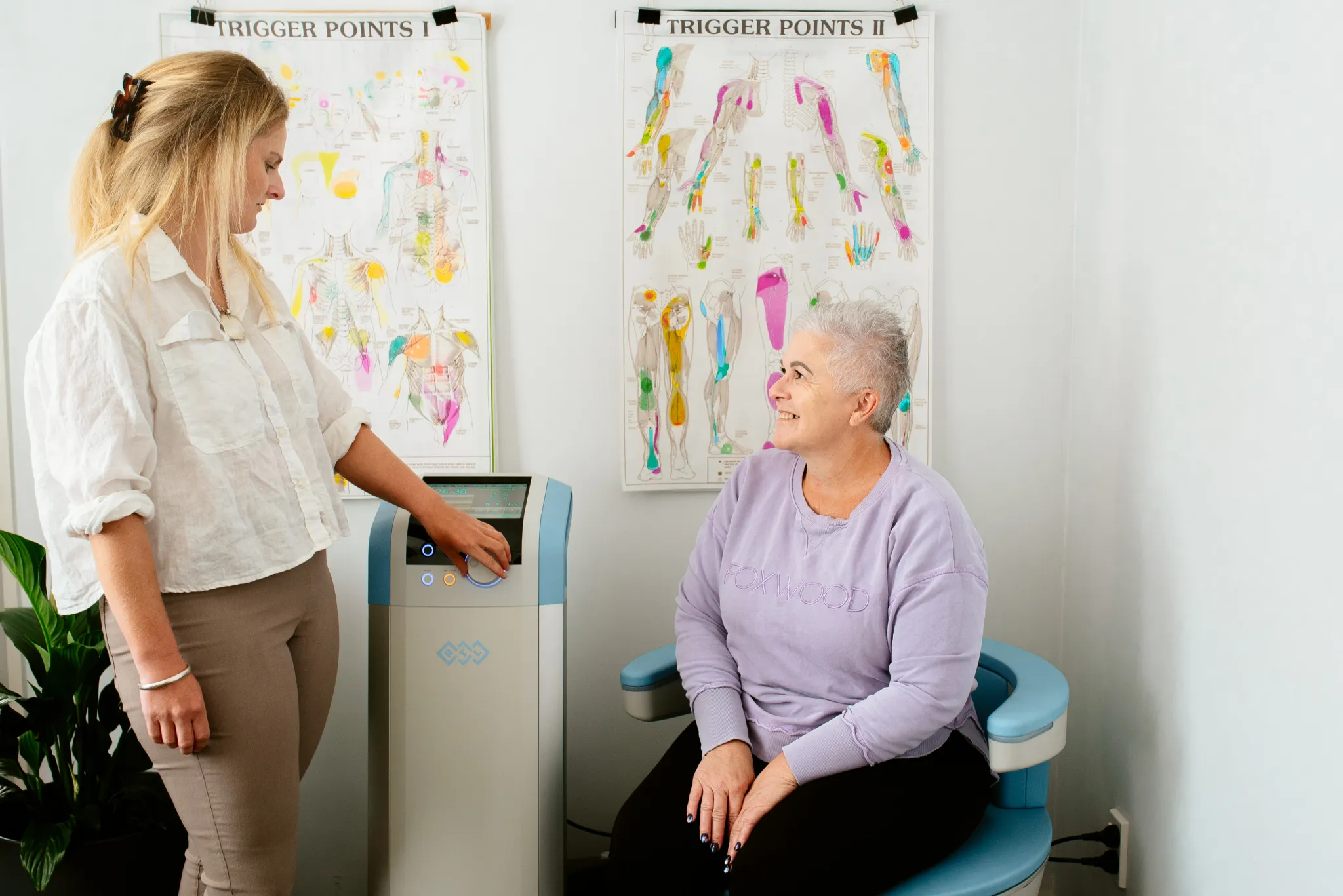 Anna with a client seated on the EMSella chair